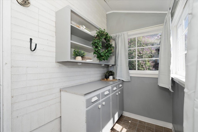bar featuring crown molding and baseboards