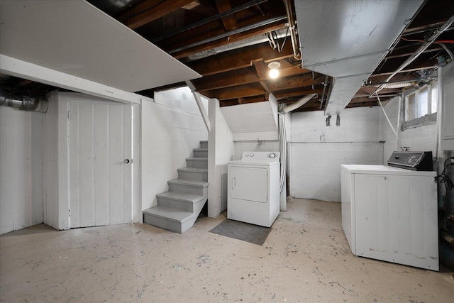 unfinished below grade area featuring stairway and washer and clothes dryer