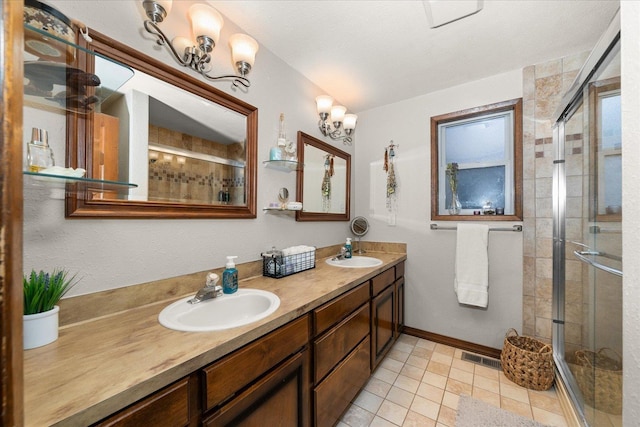 full bath with double vanity, a sink, a stall shower, and visible vents