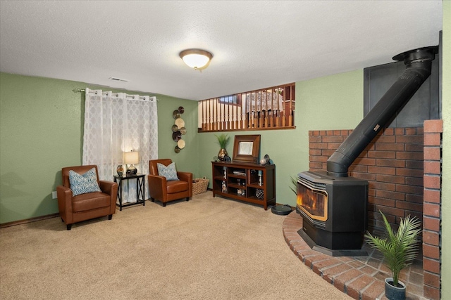 living area with carpet floors, a textured ceiling, and a wood stove
