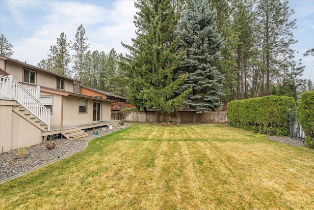 view of yard with fence and stairway