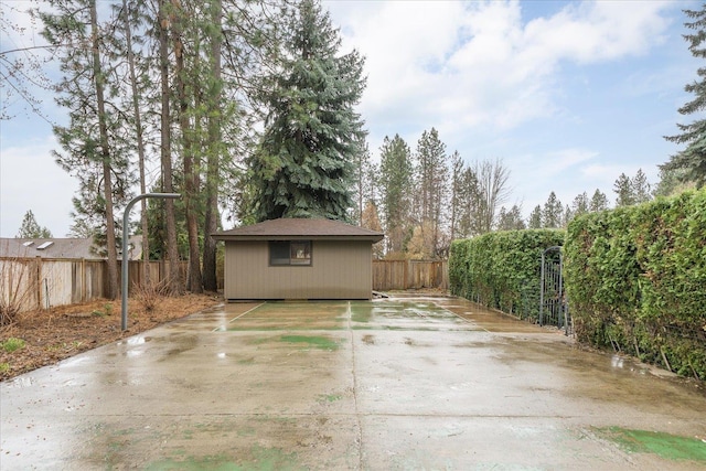 view of patio with an outdoor structure and a fenced backyard