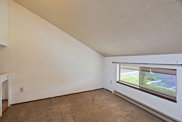 spare room with a textured ceiling, vaulted ceiling, a baseboard heating unit, and carpet floors