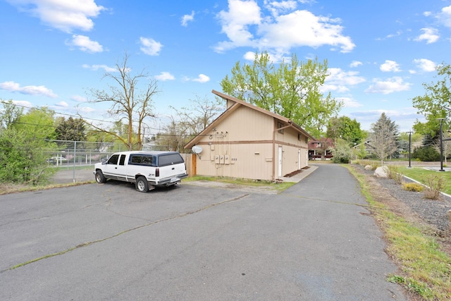 view of side of home featuring fence
