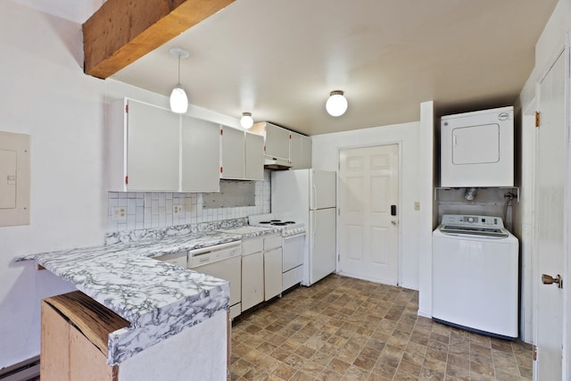 kitchen with white appliances, a baseboard heating unit, backsplash, stone finish flooring, and stacked washing maching and dryer