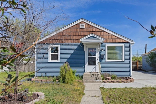 bungalow featuring fence and entry steps