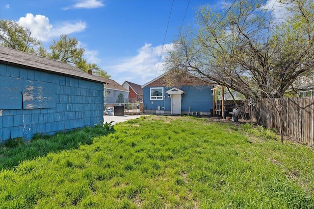 view of yard featuring an outdoor structure and a fenced backyard