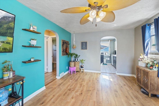 interior space featuring plenty of natural light, arched walkways, and ceiling fan