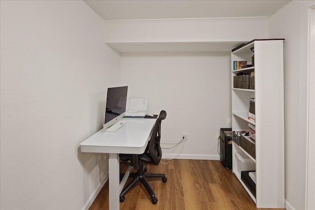 office space with baseboards, ornamental molding, and wood finished floors