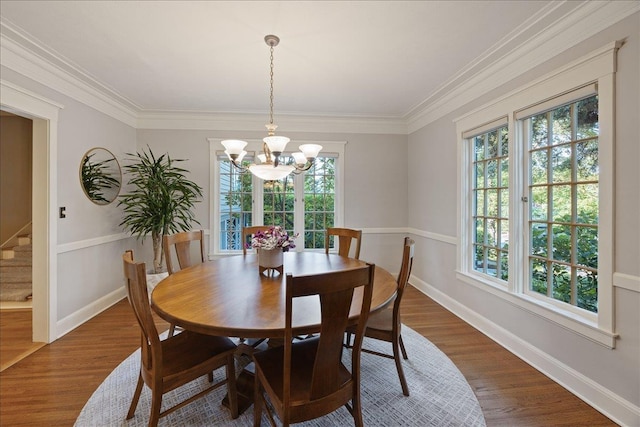 dining space featuring dark wood finished floors, a notable chandelier, stairs, and a healthy amount of sunlight