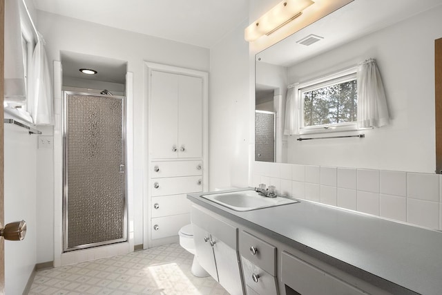 full bathroom with vanity, tile patterned floors, a shower stall, and visible vents