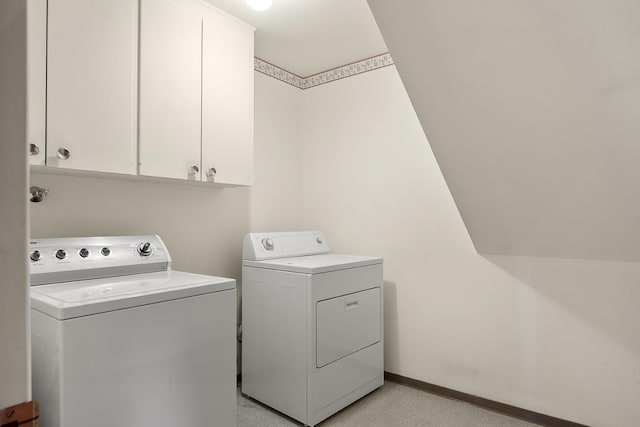laundry area with baseboards, cabinet space, and washer and clothes dryer