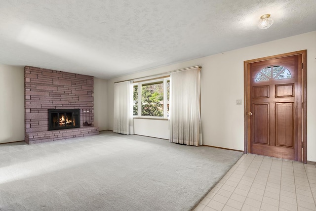 unfurnished living room featuring a textured ceiling, a healthy amount of sunlight, and a fireplace