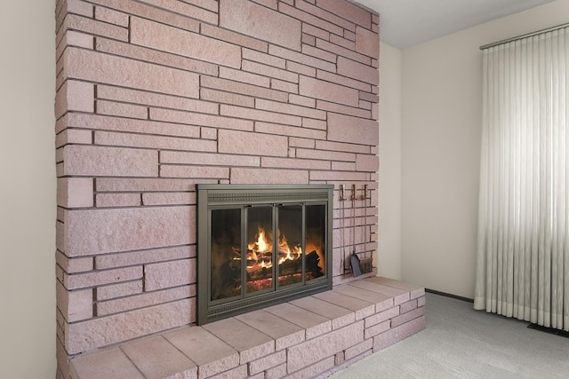 room details featuring a fireplace and carpet flooring