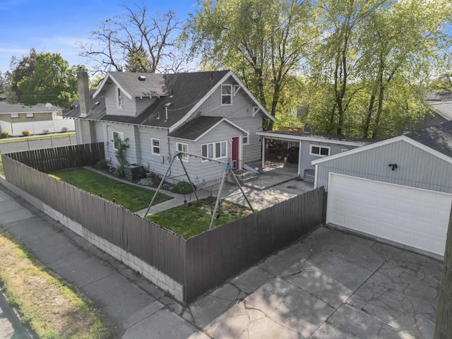 view of front of home with fence private yard, cooling unit, a chimney, a shingled roof, and an outbuilding