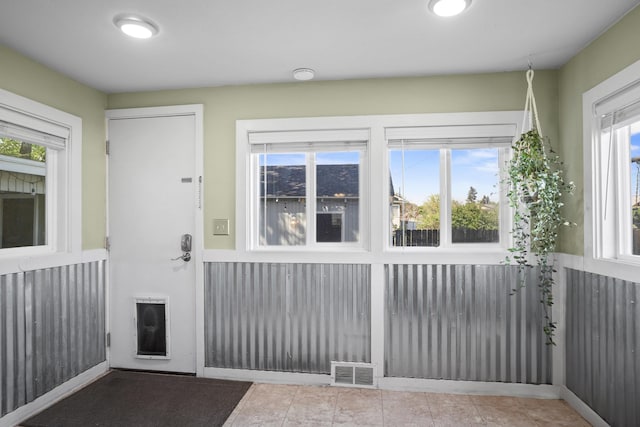 interior space featuring tile patterned flooring and visible vents