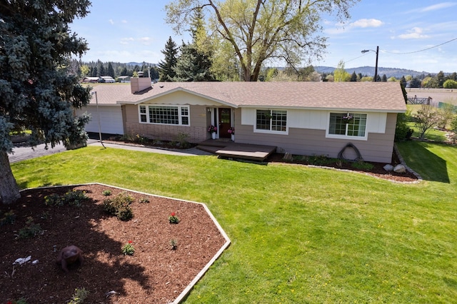 ranch-style home featuring a chimney, a garage, a mountain view, and a front yard
