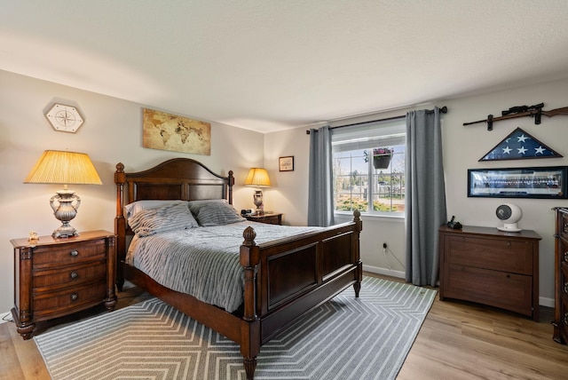 bedroom featuring baseboards and light wood-style flooring