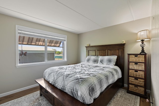 bedroom featuring baseboards and wood finished floors