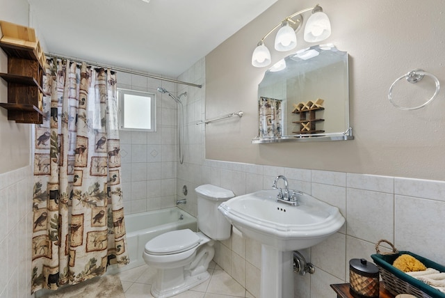 bathroom with shower / bath combo with shower curtain, toilet, tile walls, a wainscoted wall, and tile patterned floors