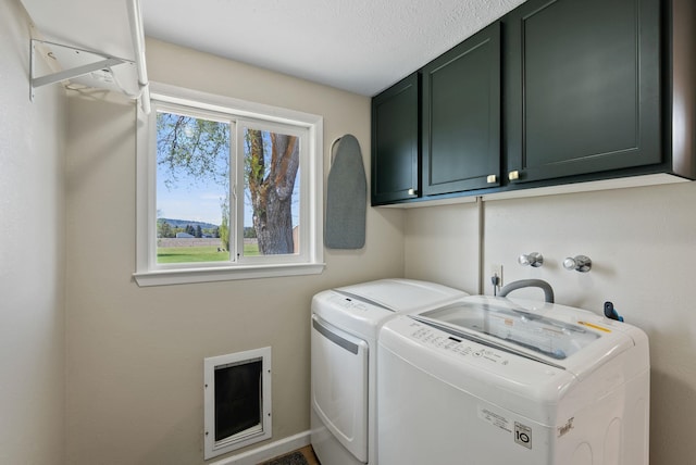 laundry room featuring cabinet space and washing machine and dryer