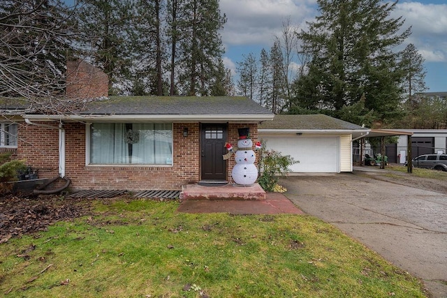 single story home with a chimney, a carport, a garage, brick siding, and aphalt driveway