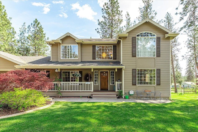 16503 N Mockingbird Ln, Nine Mile Falls, WA 99026 - view of front facade featuring roof with shingles, covered porch, and a front yard