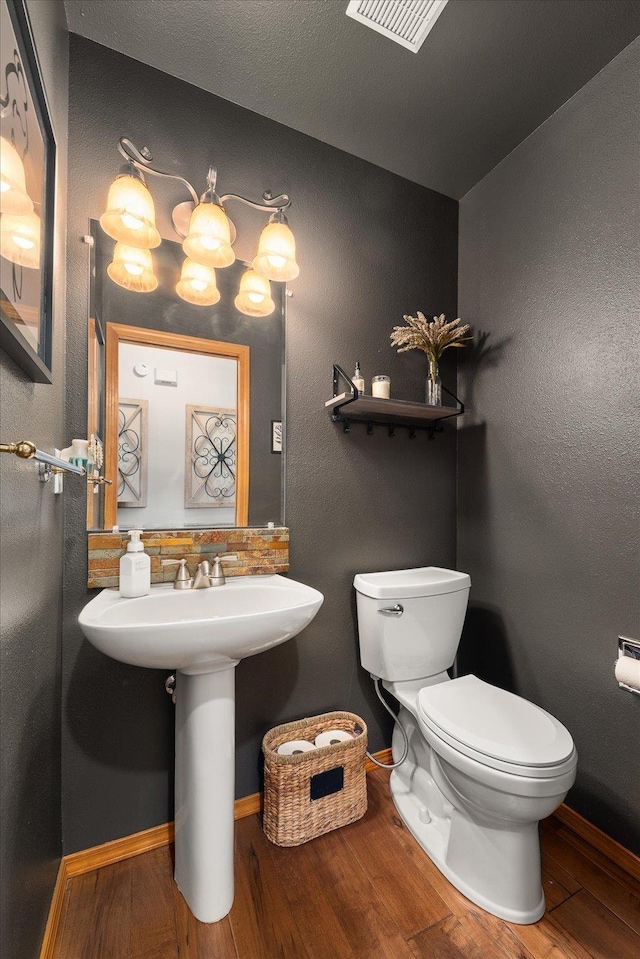 16503 N Mockingbird Ln, Nine Mile Falls, WA 99026 - half bathroom with baseboards, toilet, wood finished floors, and visible vents