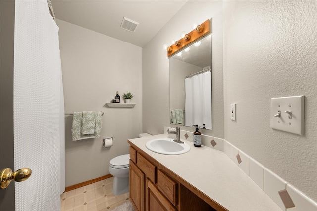 16503 N Mockingbird Ln, Nine Mile Falls, WA 99026 - full bath with vanity, toilet, tile patterned floors, baseboards, and visible vents