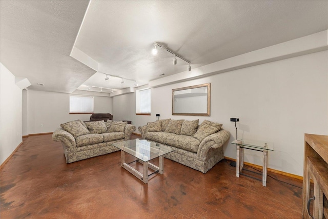 16503 N Mockingbird Ln, Nine Mile Falls, WA 99026 - living area with baseboards, concrete flooring, rail lighting, and a textured ceiling
