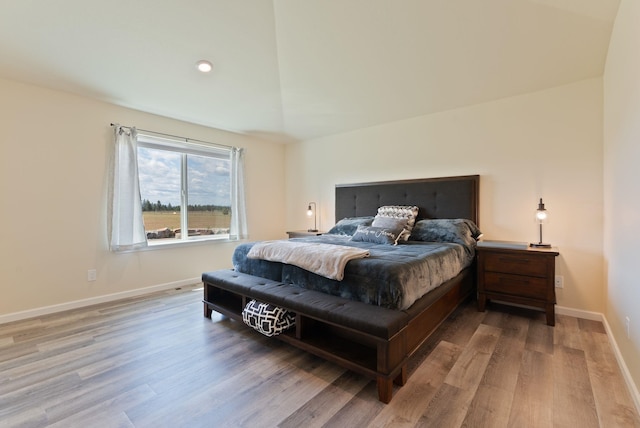 bedroom featuring baseboards and wood finished floors