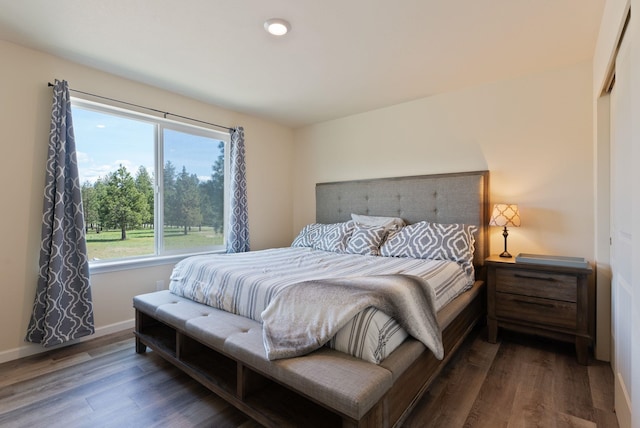 bedroom featuring baseboards and wood finished floors