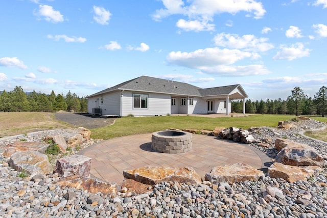 back of property featuring an outdoor fire pit, a patio area, a yard, and cooling unit