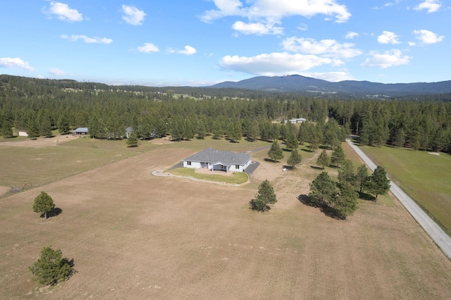 aerial view with a mountain view and a forest view
