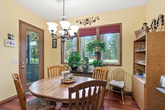 420 Palmer Ln, Chewelah, WA 99109 - dining space with baseboards, a notable chandelier, and wood finished floors