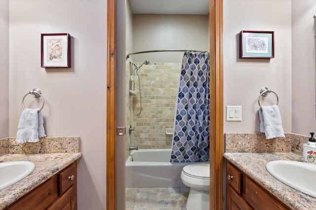 full bathroom with vanity, shower / tub combo, and toilet