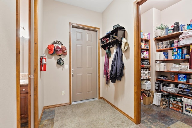 foyer featuring baseboards