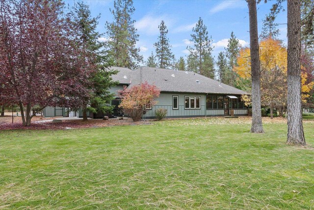 420 Palmer Ln, Chewelah, WA 99109 - back of property featuring a lawn and roof with shingles