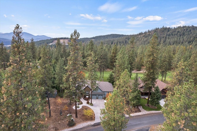 birds eye view of property featuring a mountain view and a wooded view