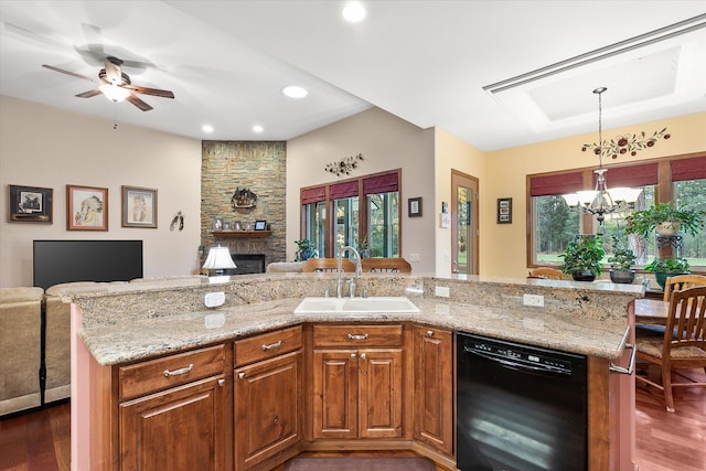 kitchen featuring a fireplace, dark wood finished floors, a sink, open floor plan, and black dishwasher