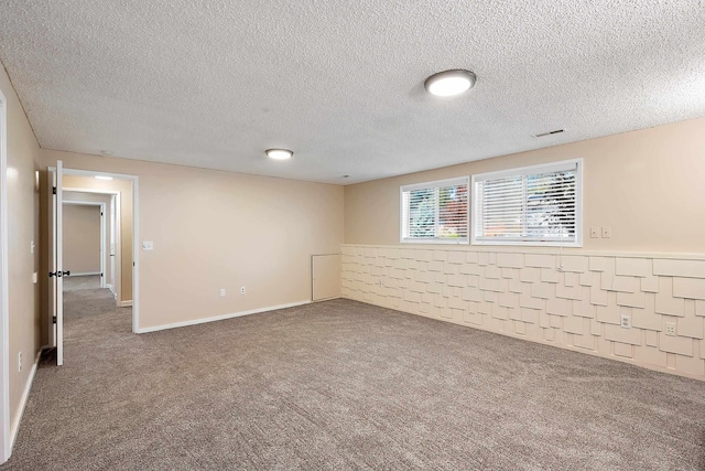 interior space with a textured ceiling, visible vents, and carpet