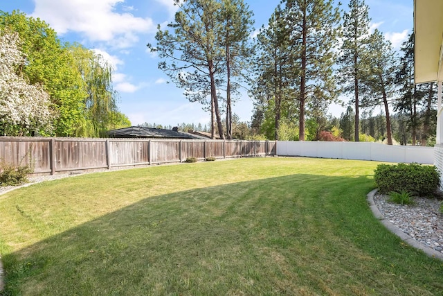 view of yard with a fenced backyard