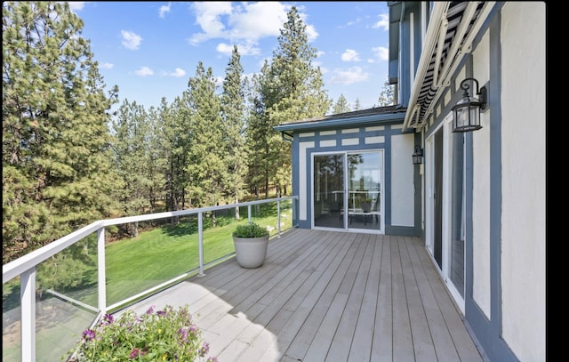wooden deck with a lawn