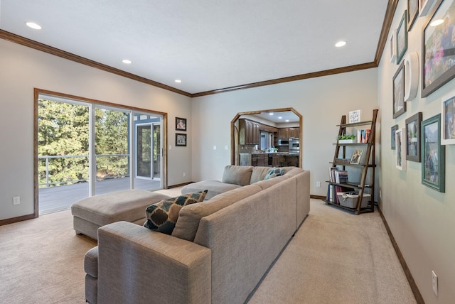 living room with crown molding, baseboards, recessed lighting, light colored carpet, and arched walkways