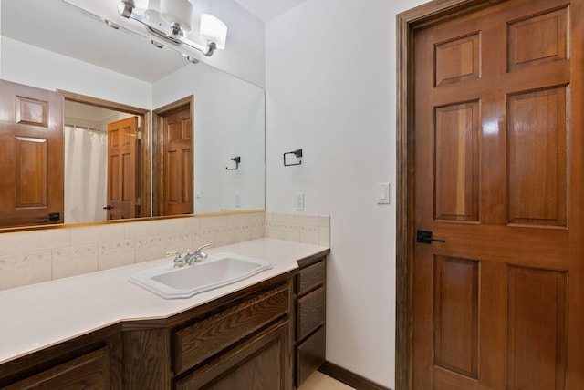 full bathroom featuring vanity and tasteful backsplash