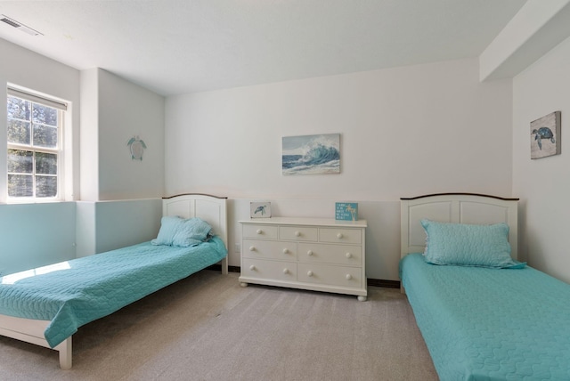 bedroom featuring light carpet and visible vents