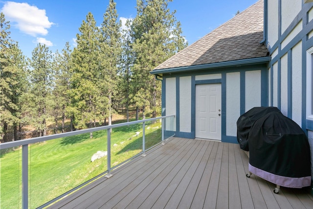 wooden deck featuring a yard