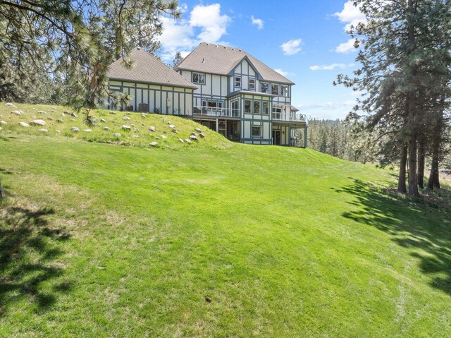 view of yard featuring a wooden deck and a sunroom