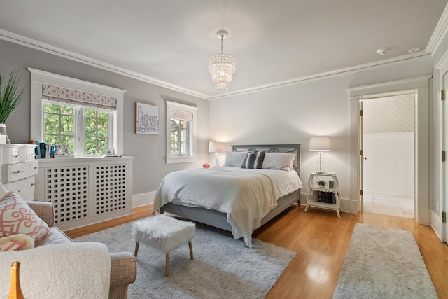 615 E 16th Ave, Spokane, WA 99203 - bedroom featuring an inviting chandelier, wood finished floors, baseboards, and ornamental molding