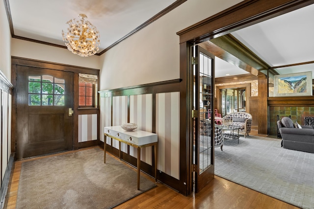 615 E 16th Ave, Spokane, WA 99203 - entrance foyer featuring crown molding, wood finished floors, and an inviting chandelier